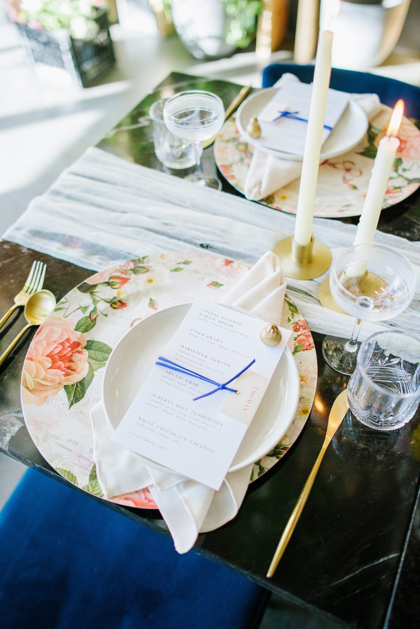 Wedding reception table decor with spring florals and royal blue accents