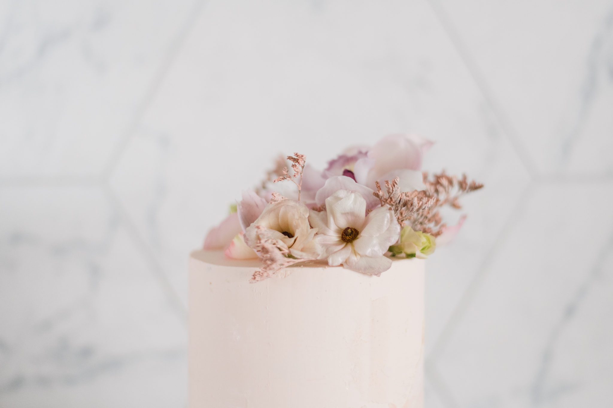 Cute wedding cake with pink blossoms 