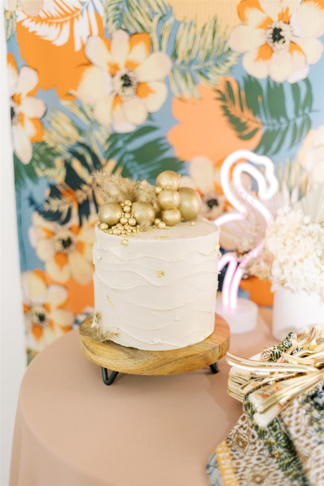 Golden single-tier cake for a tropical bridesmaid proposal party