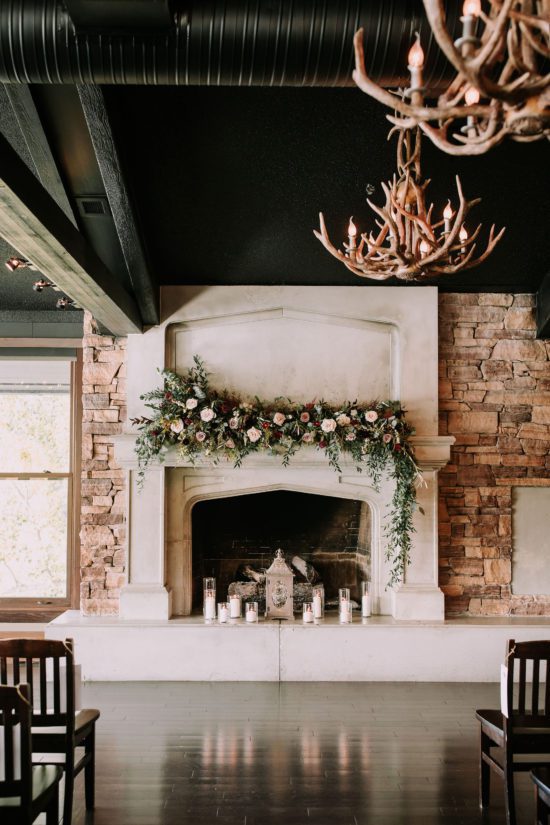 Rustic wedding venue with fireplace and antler chandeliers