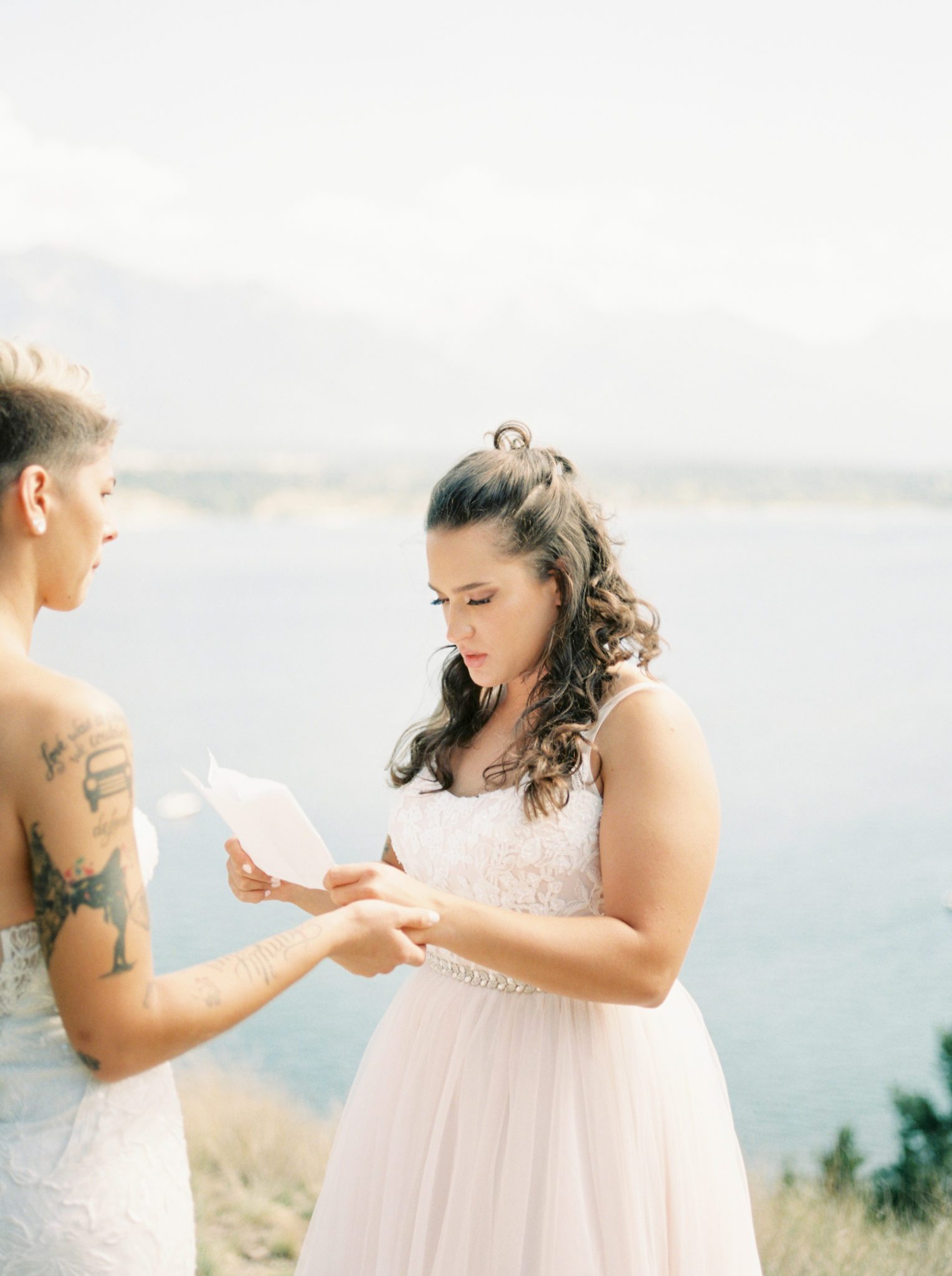 Brides exchange intimate wedding vows lakeside