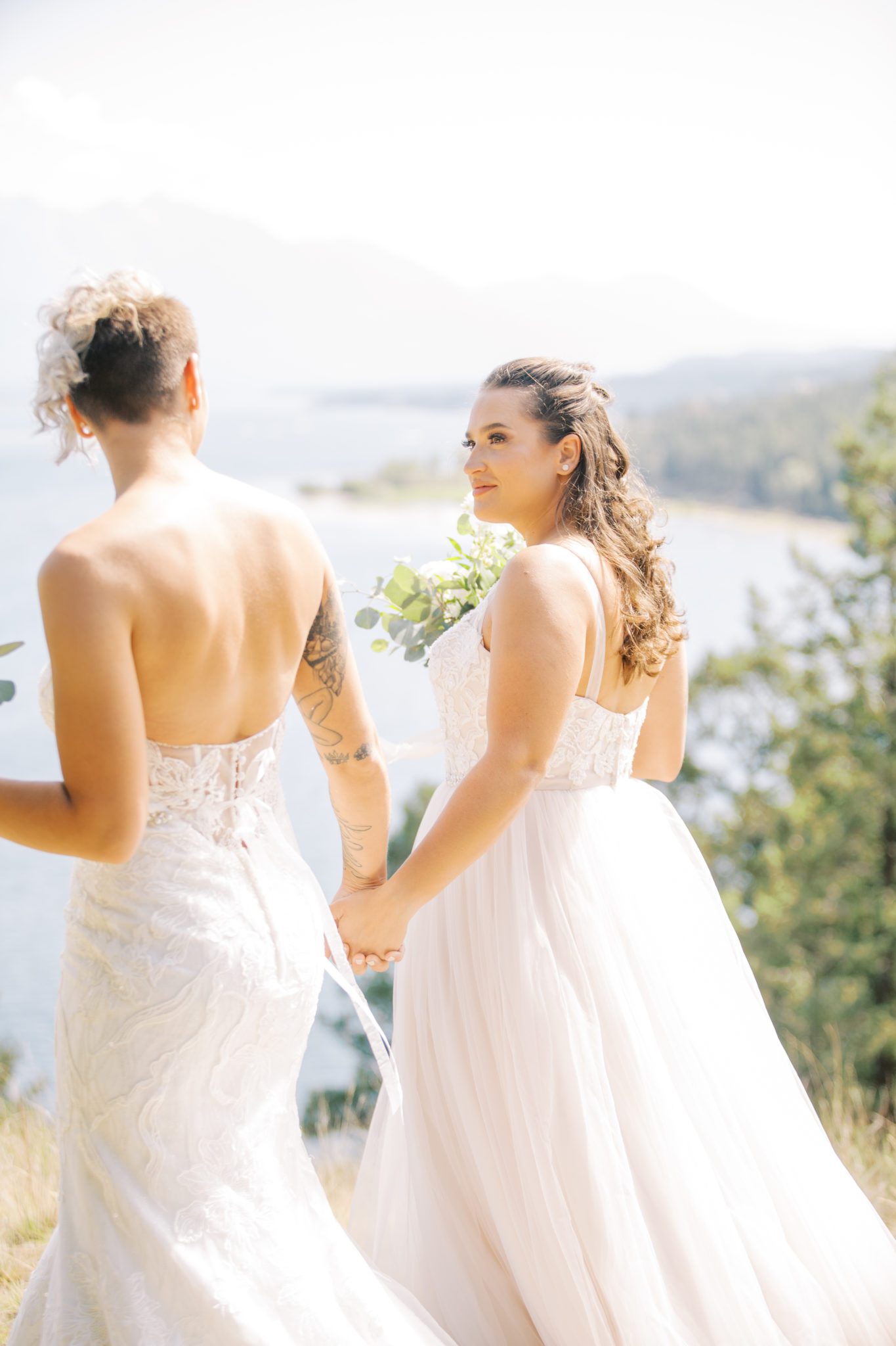 Newly weds walk hand in hand along Lake Windermere