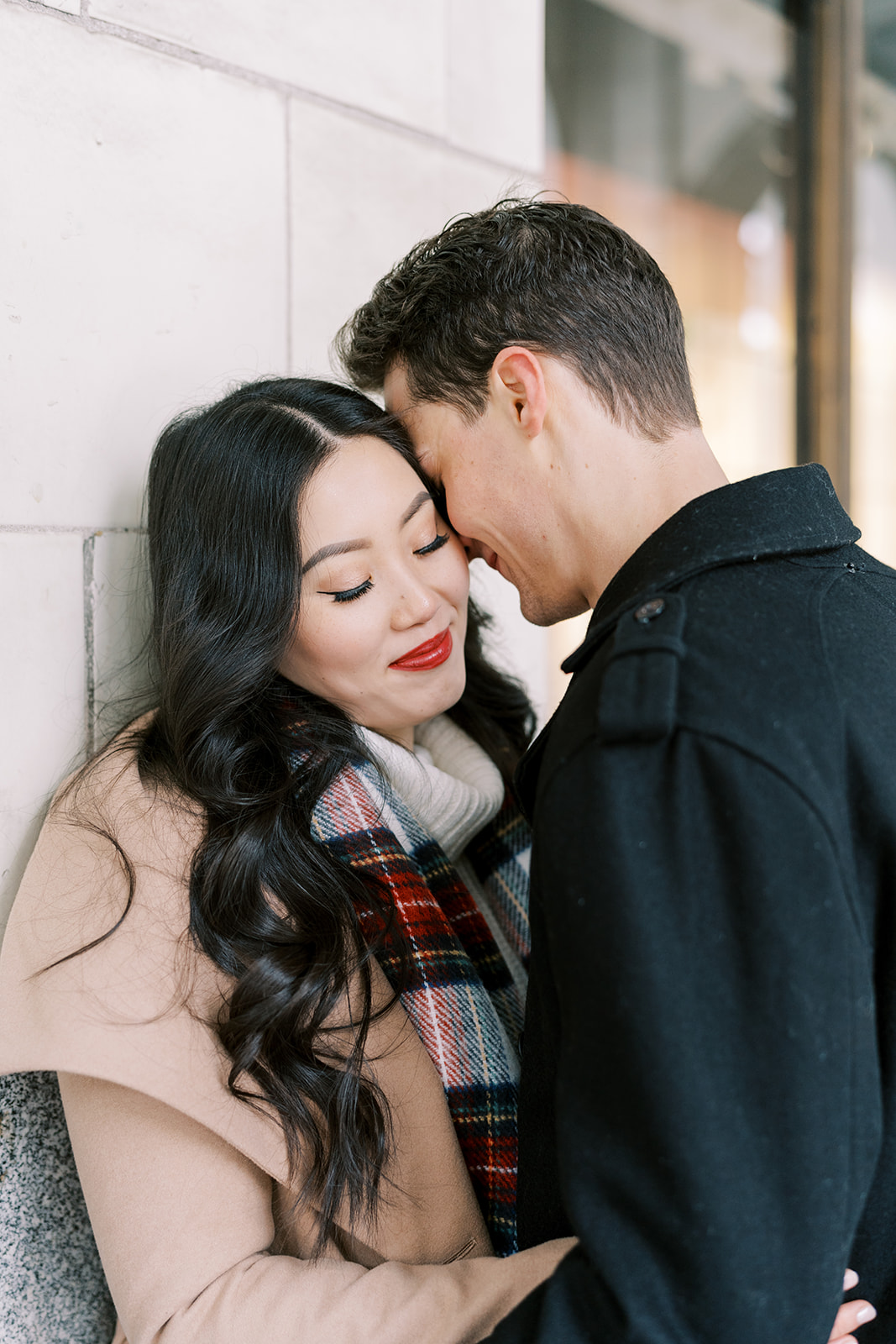 Cute couple posing for downtown engagement session, 10 Winter Wedding Ideas & Planning Tips to Help You Nail Your Own Winter Wedding