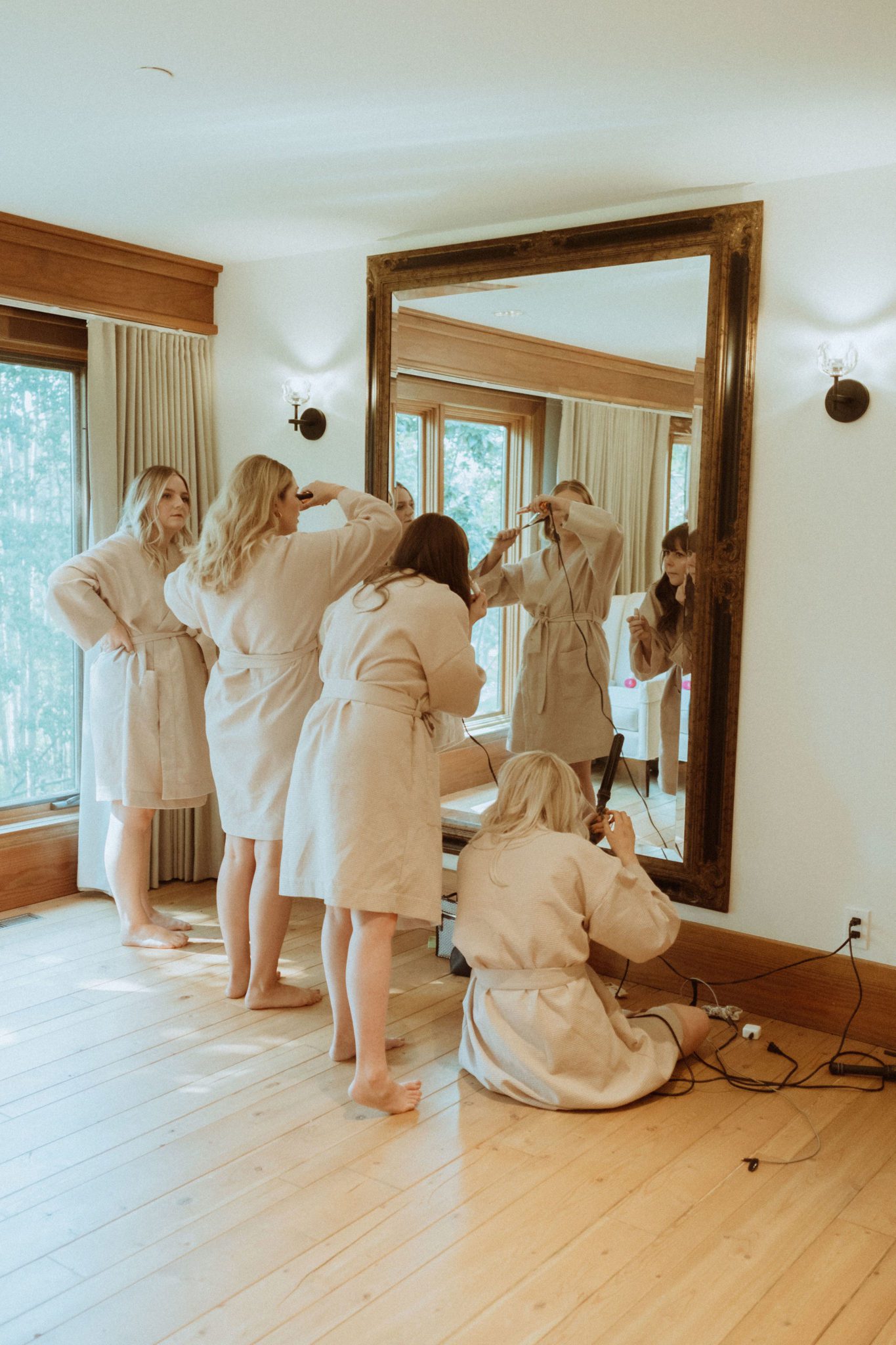 Bridal party prepares for suprise wedding in dusty rose robes