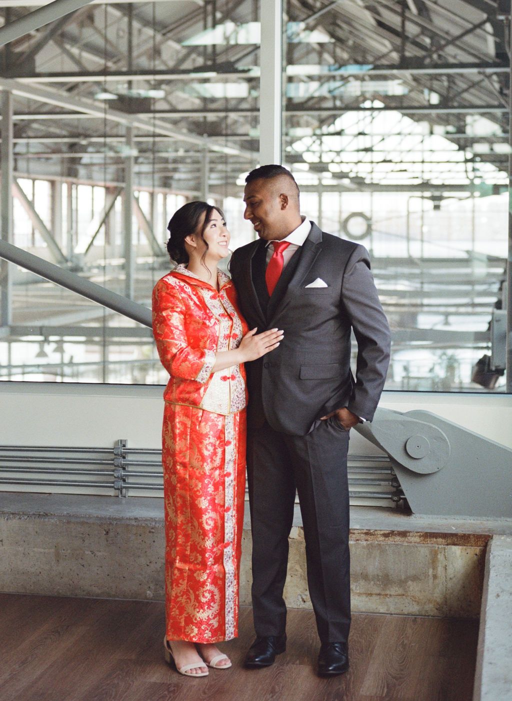  Multicultural wedding inspiration in Vancouver, bride and groom attire with bright red accents