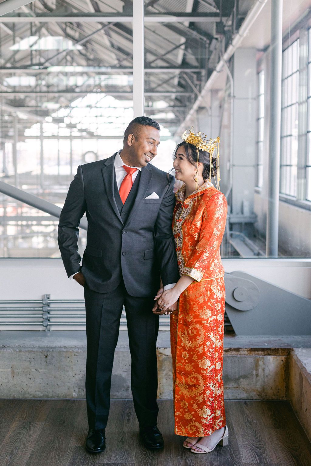 Multicultural wedding inspiration in Vancouver, bride and groom attire with bright red accents