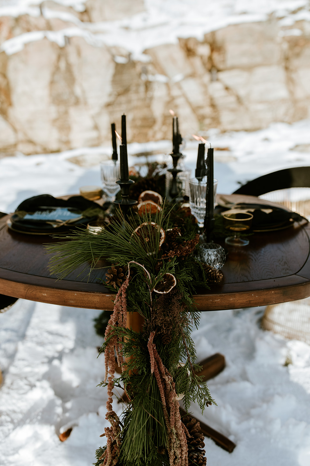 Winter Wedding Sweetheart Table with Green garland and candied oranges, black candlesticks, rustic vintage wedding style