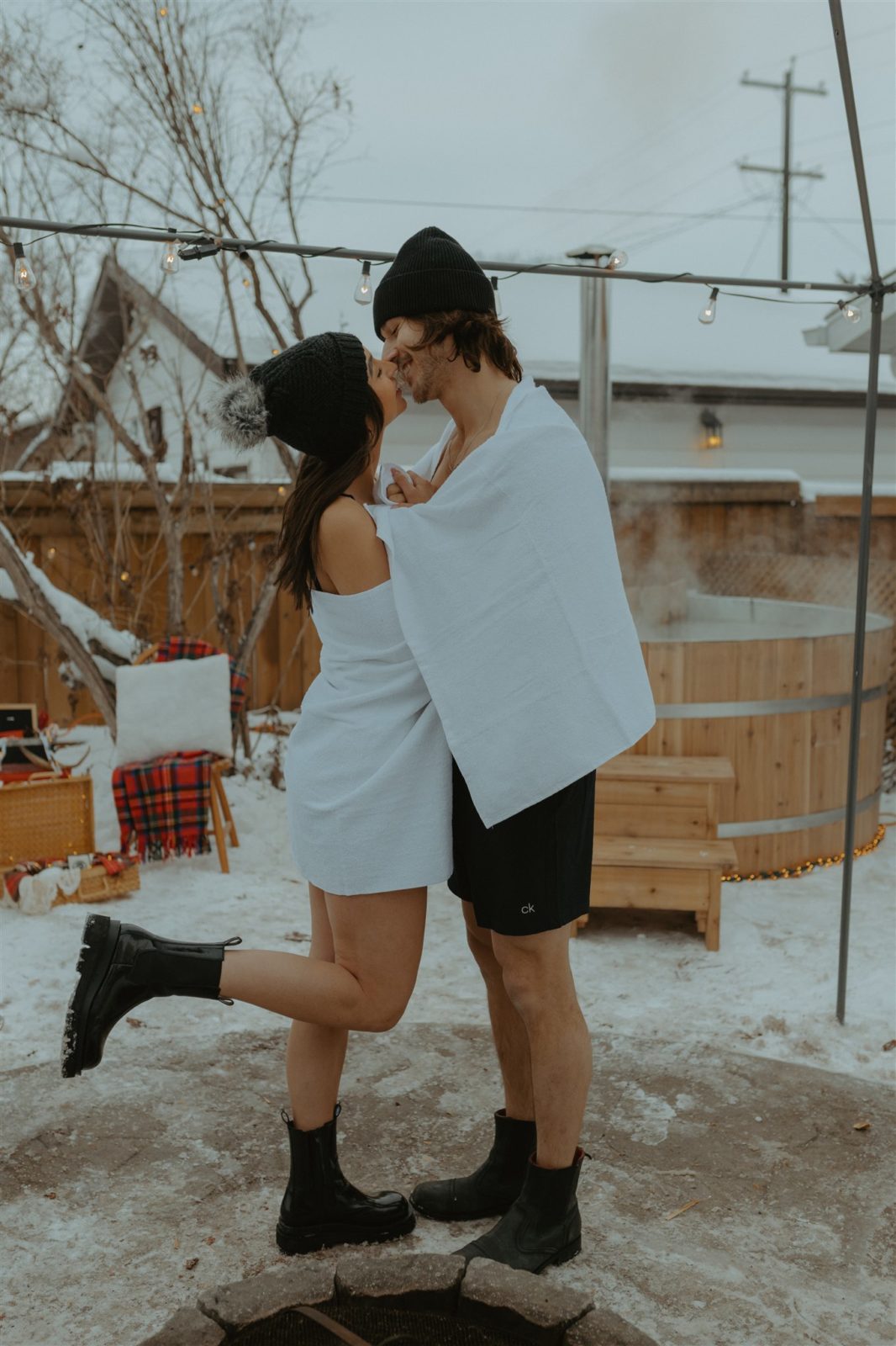 Couple gets ready for unique hot tub engagement session activity during Alberta winter