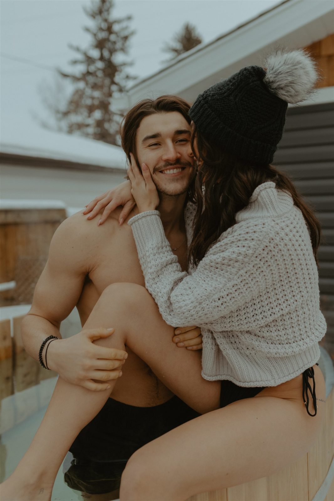 Engagement session activity with hot tub, toques, and sweaters