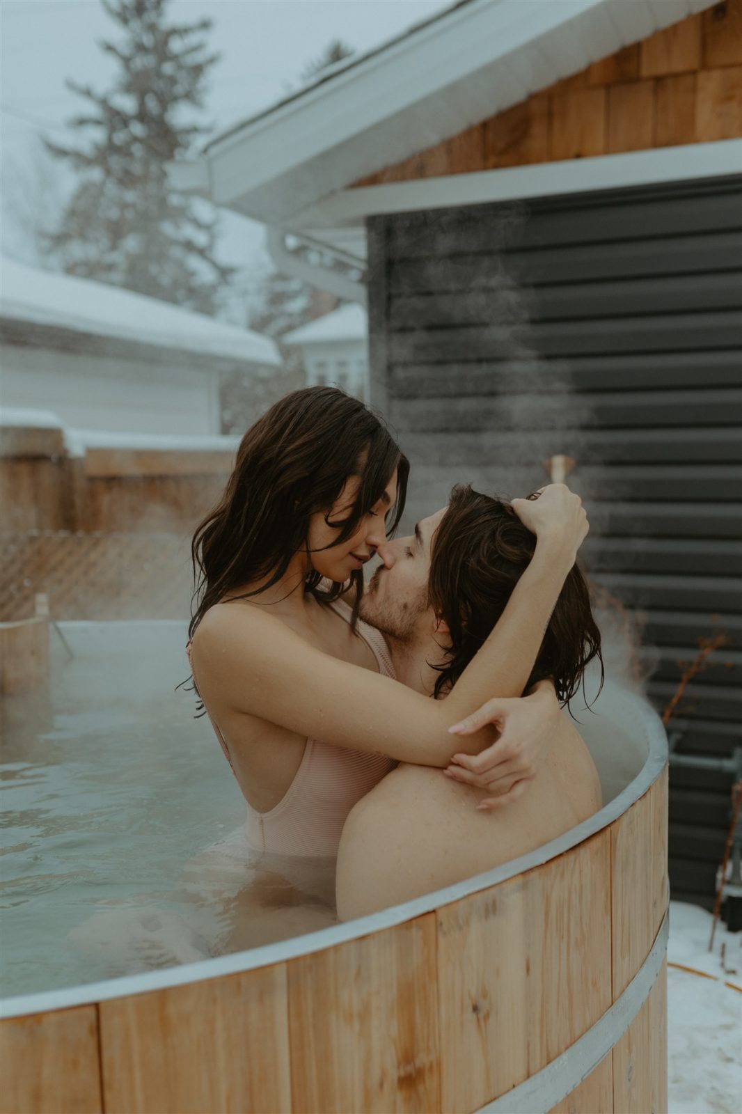 Outdoor couple portraits in steamy hot tub, Alberta engagement session activity ideas