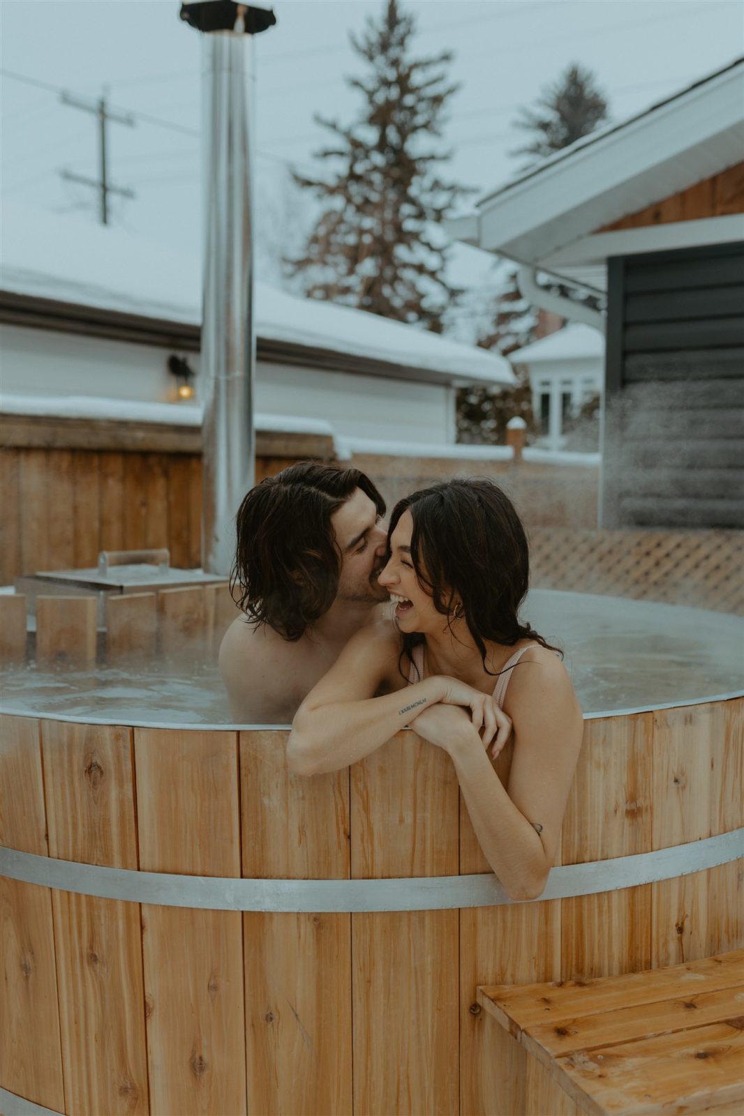 Hot tub photo session in Alberta at winter time, unique engagement session activity