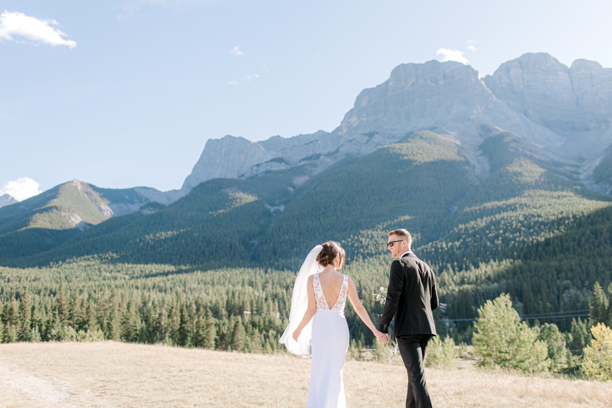 Outdoor wedding in Canmore, Alberta features Chic crepe wedding dress.