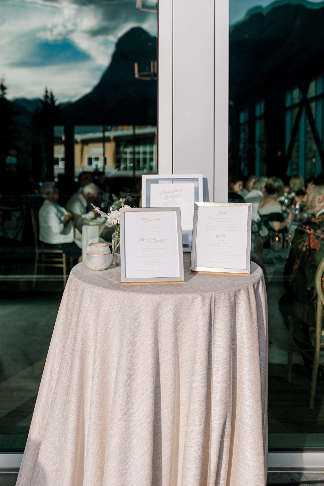 Blush and green welcome sign at outdoor wedding reception