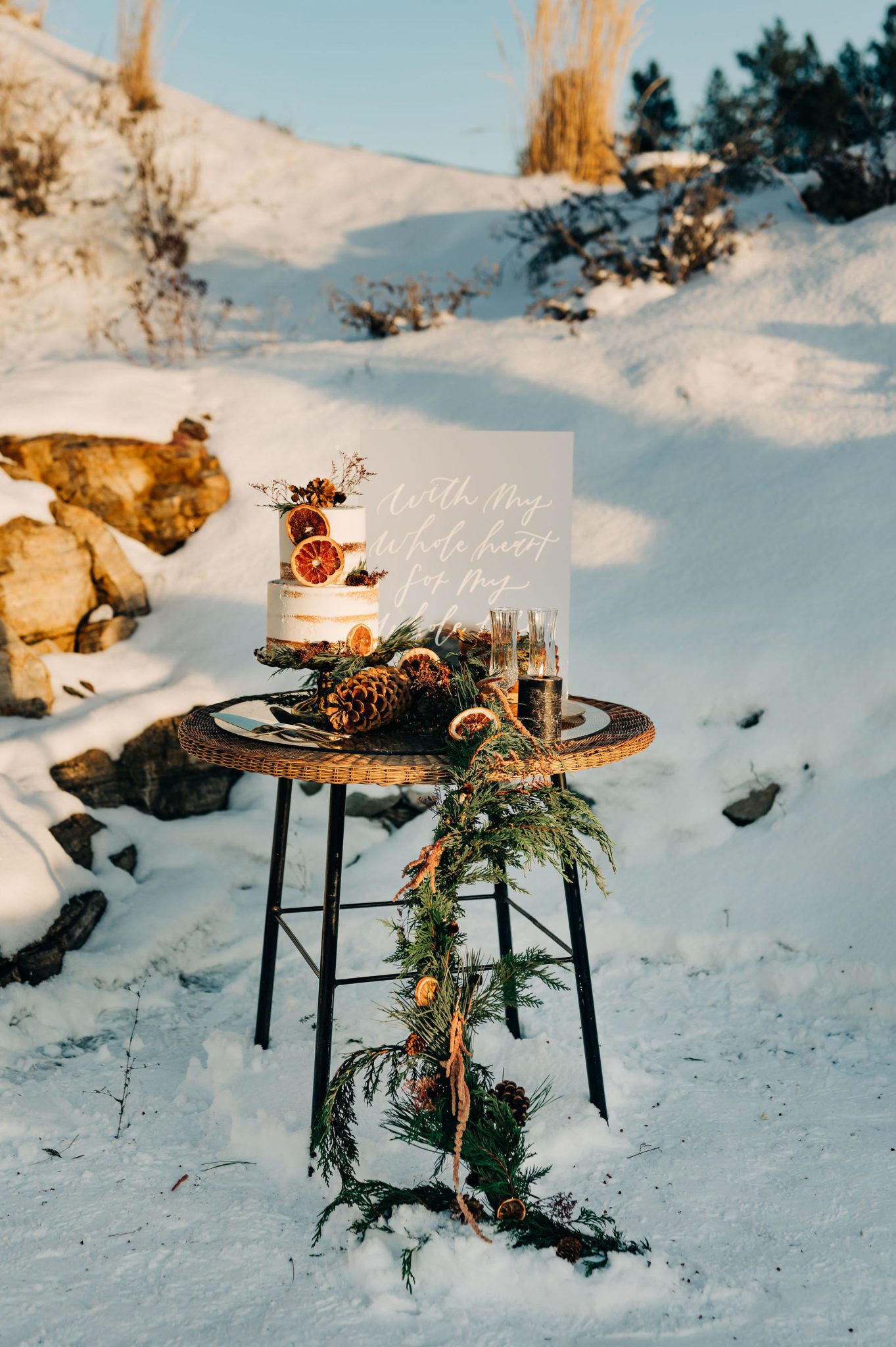 Outdoor winter elopement inspiration with naked cake and candied oranges, custom acrylic signage