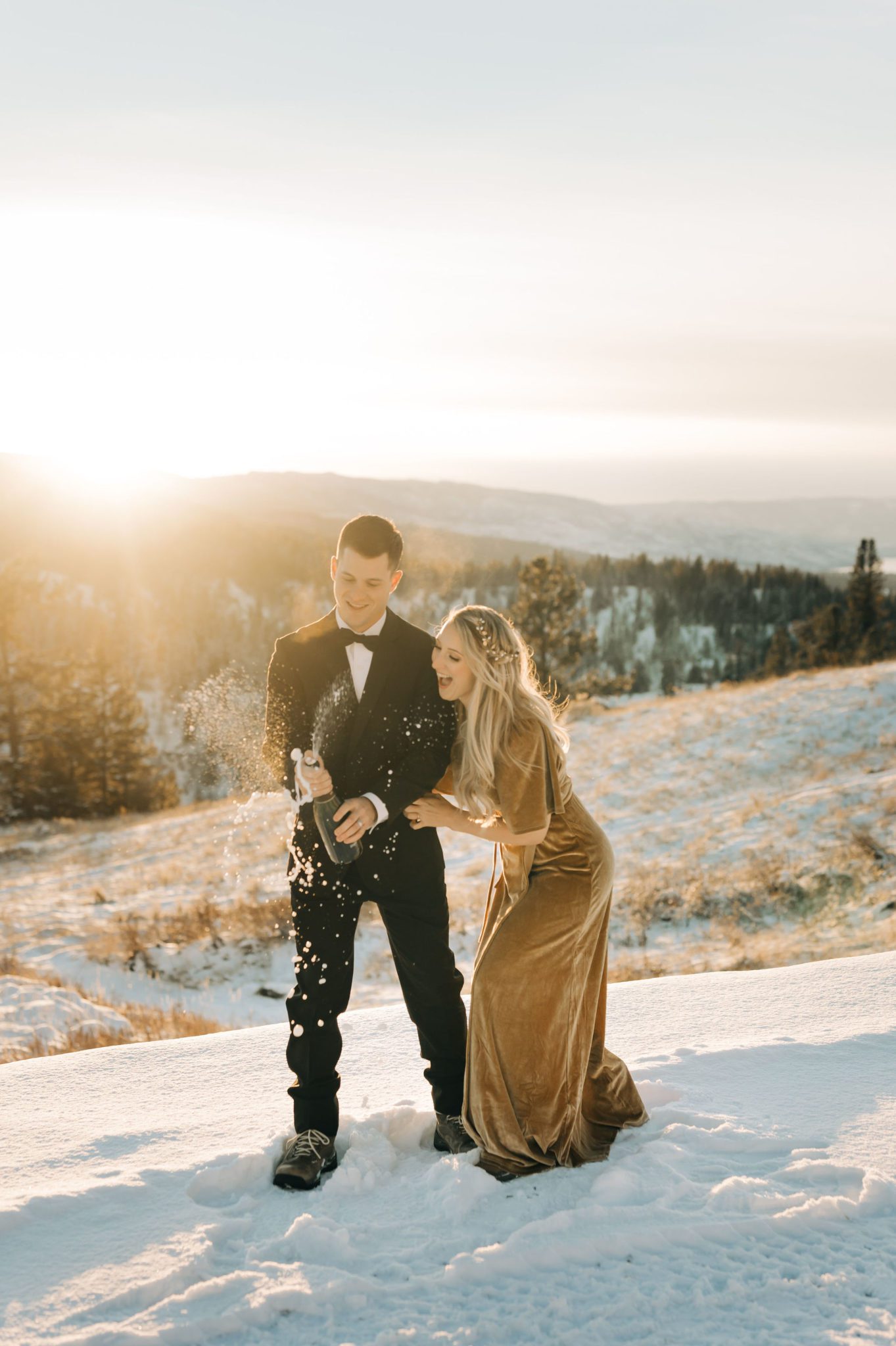 Champagne pop in the snow at outdoor elopement in BC, Winter wedding attire ideas, elopement inspiration