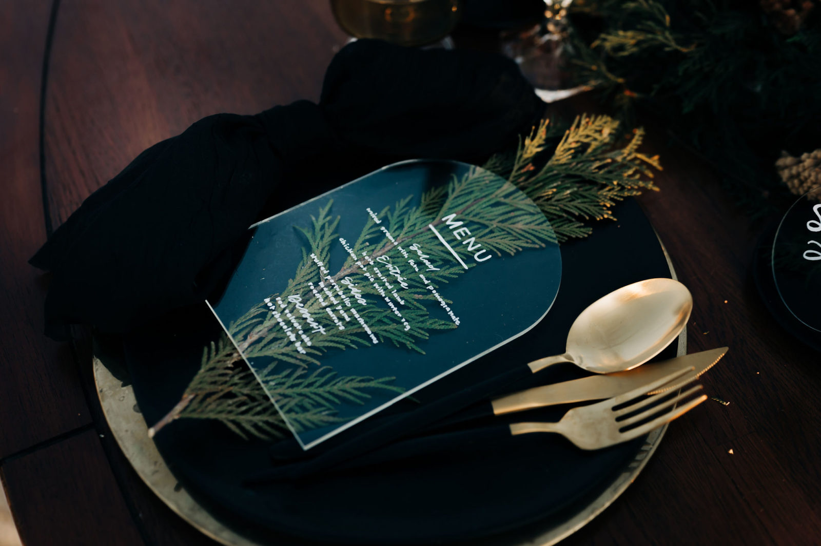 Acrylic arch menu on top of pine accent for rustic winter tablescape