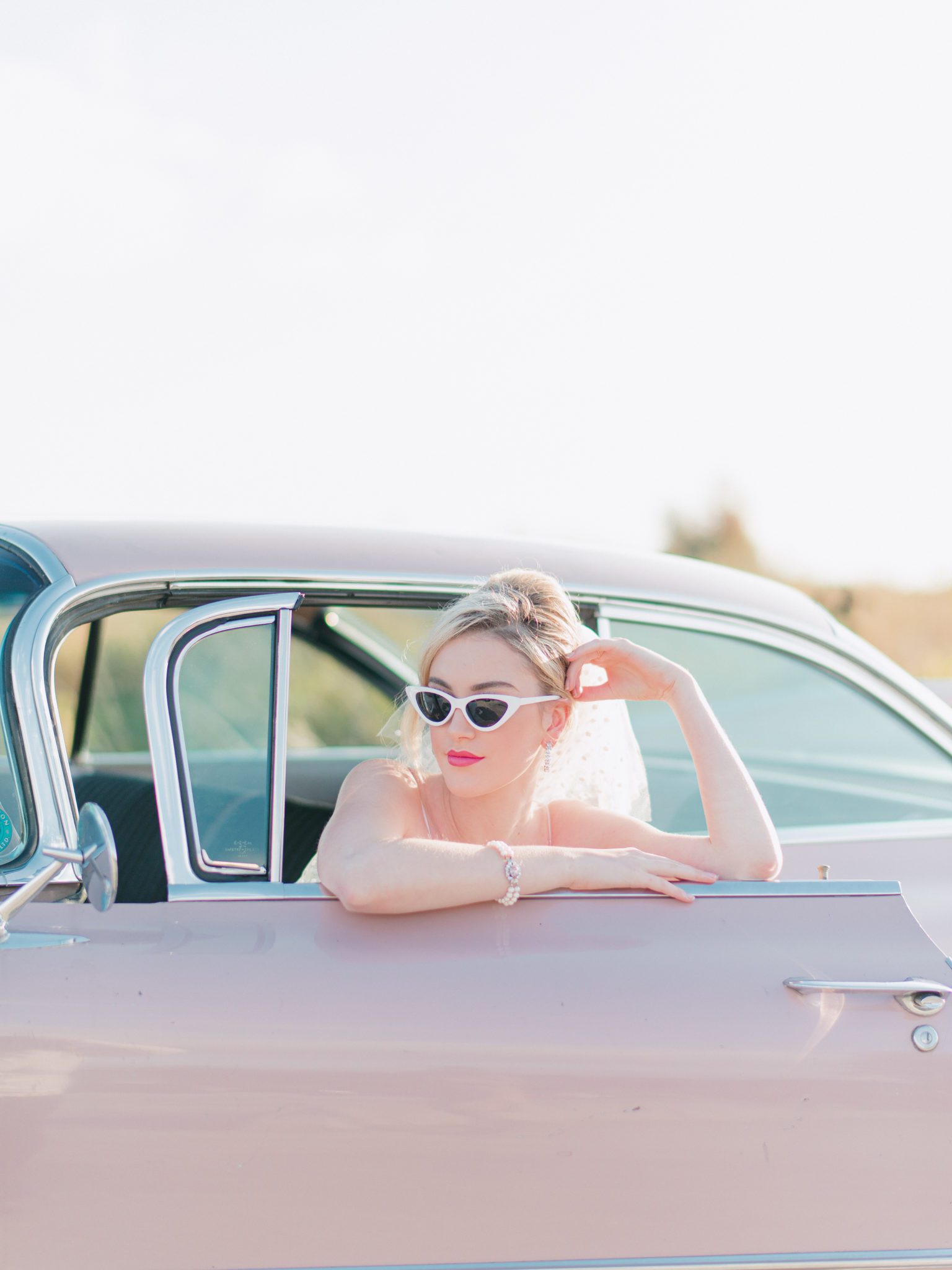 Coolest bridal vibes with cat-eye sunglasses in pink Cadillac
