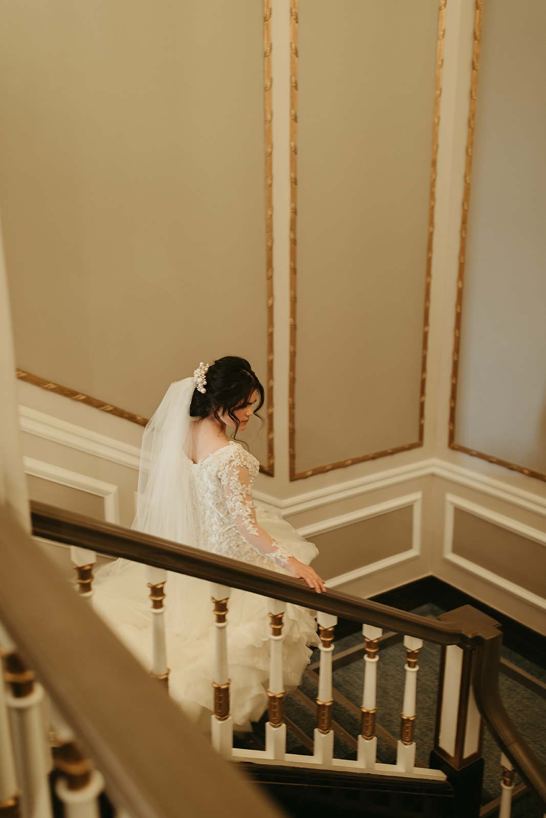 Bride walks down stairs at hotel in Saskatoon