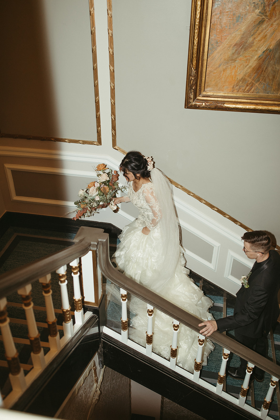 Unique couple portraits on stairs at Saskatoon vintage wedding