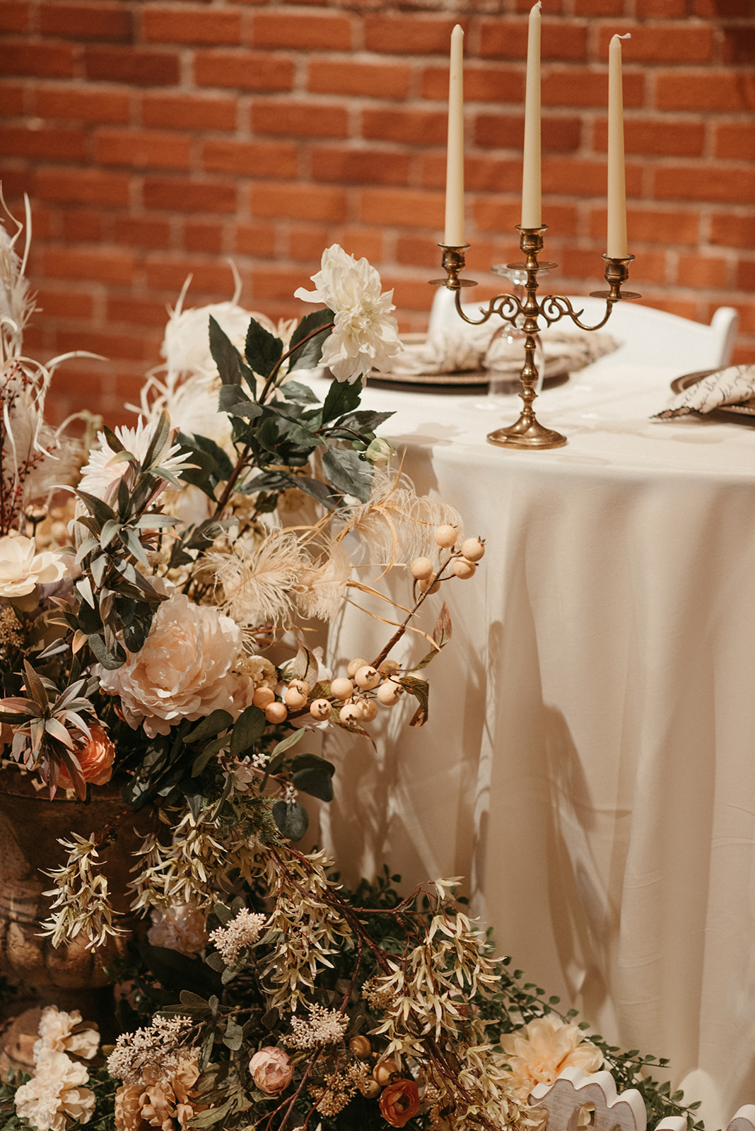 Sage and toffee wedding decor with flowers and berries