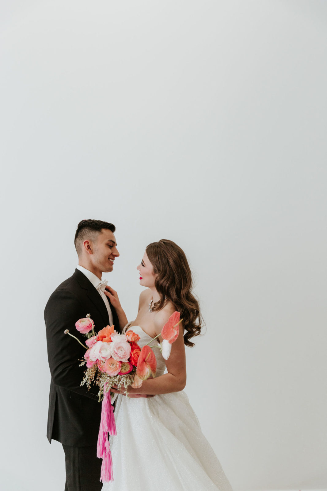 Modern and Glamorous Wedding Celebration Inspiration With A Pop of Pink | hot pink bridal bouquet, lazaro gown, tassels on bouquet