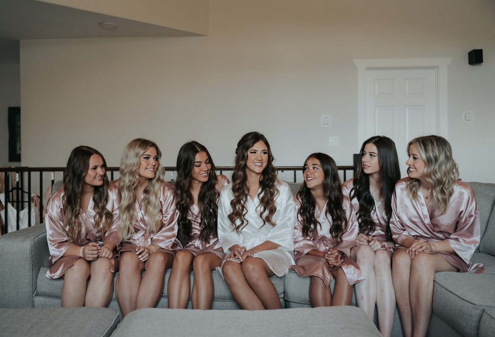 Bride and bridesmaids get ready for wedding day, bride tribe in matching robes
