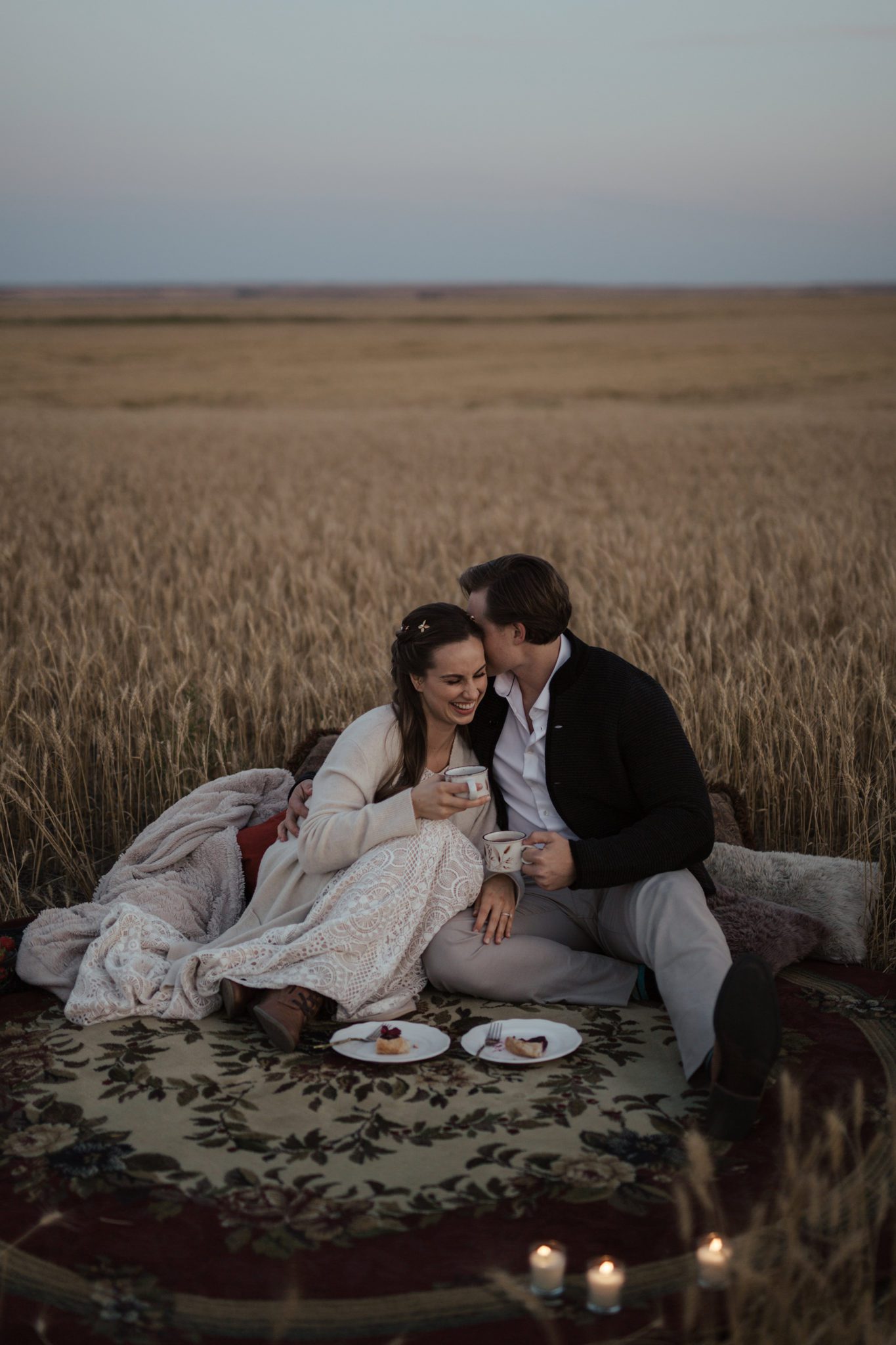 A small farmyard picnic in a rural countryside field, the bride and groom enjoy warm drinks in vintage mugs and berry galette, fall vow renewal inspiration. 
