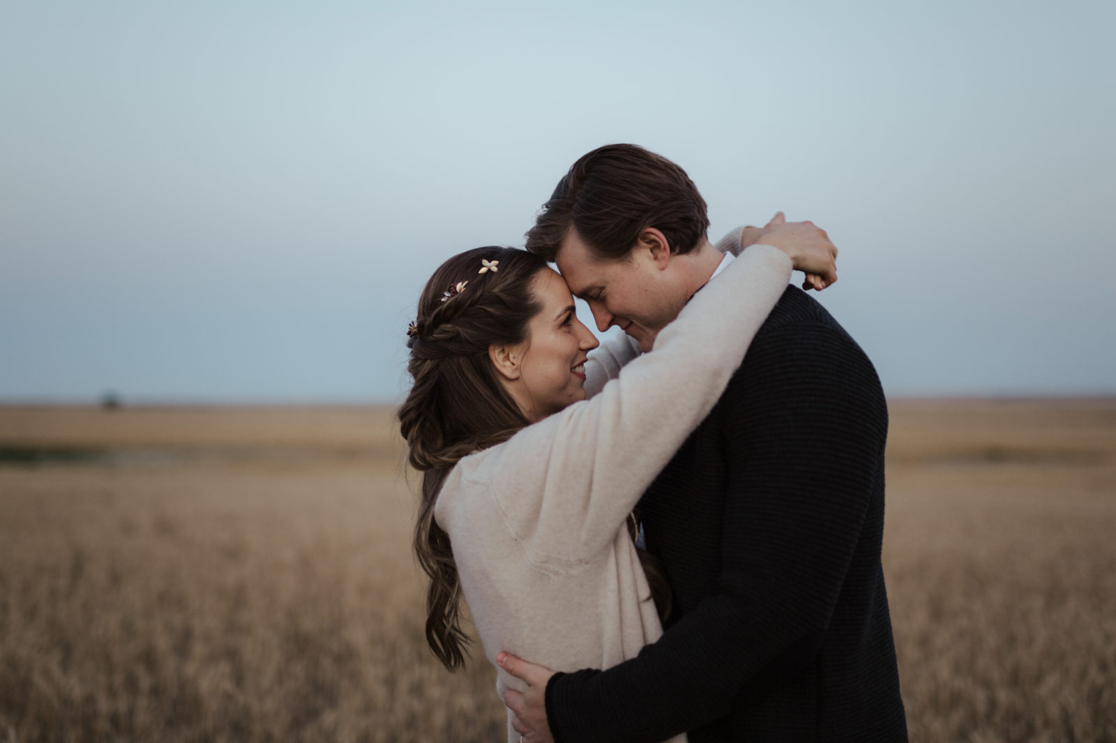 The newlyweds share a first dance in an open field, fall vow renewal inspiration. 