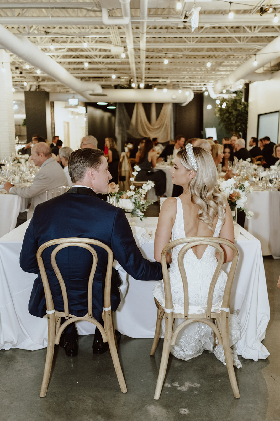 indoor garden wedding, gardenesque florals, hanging fabric installation for reception, sweetheart table