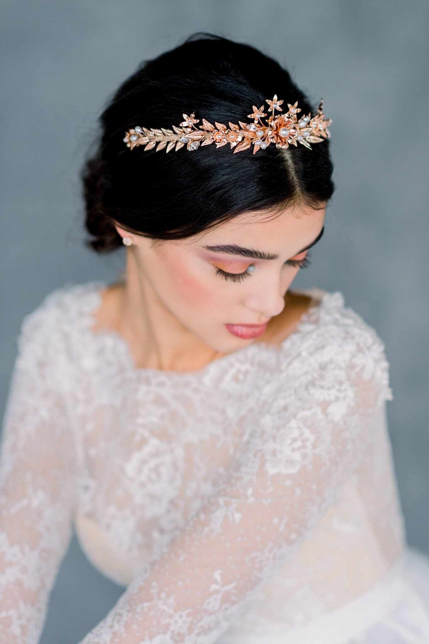 Hand plated rose gold leaves and flowers in the pretty shade are hand wired to a metal crown. Accented with Swarovski pearls and Preciosa rhinestones and finished beautifully with a soft metallic Mokuba ribbon.