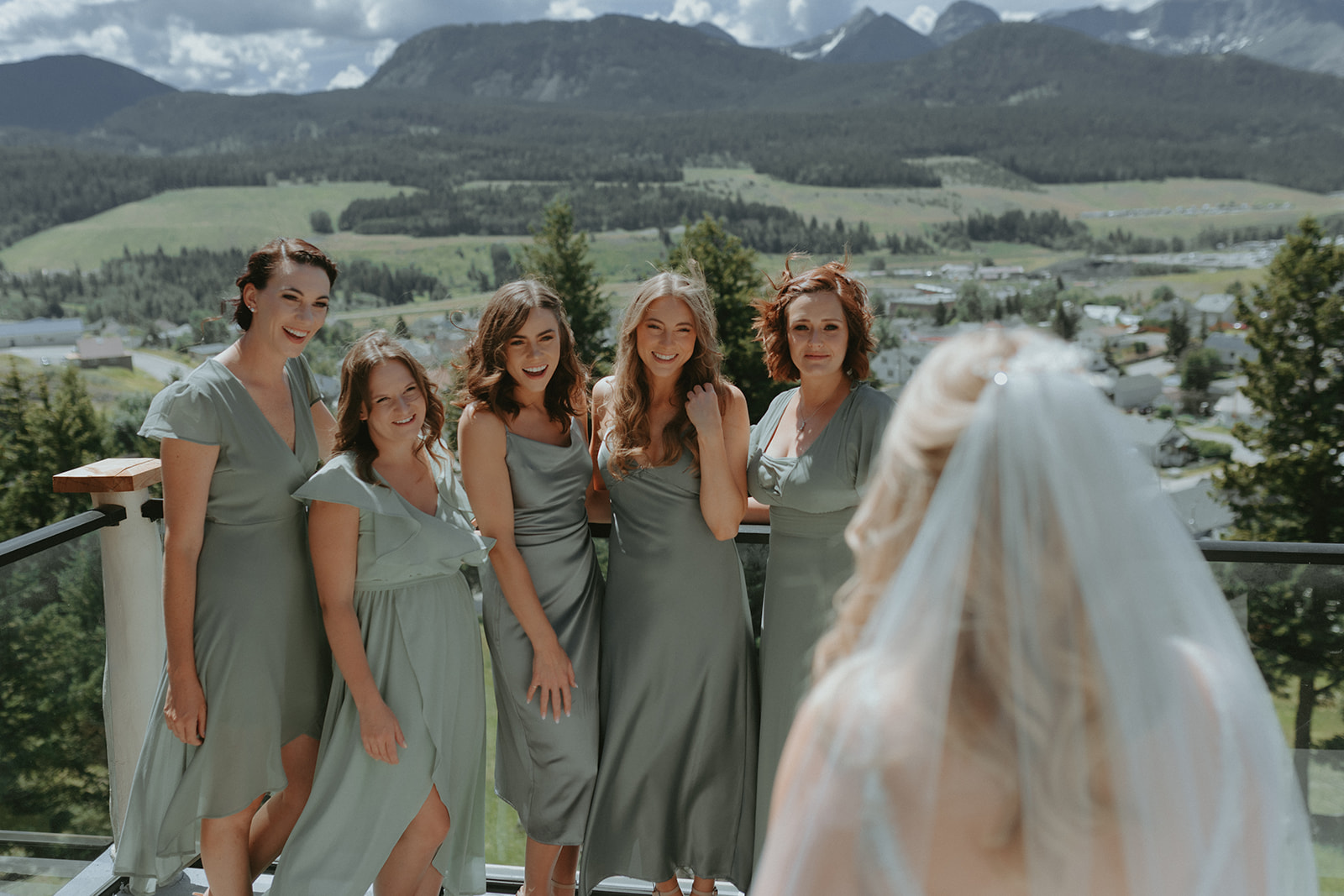 Bridal party first look in a mountain wedding. Sage Green mismatched bridesmaid dresses in this sage wedding inspiration