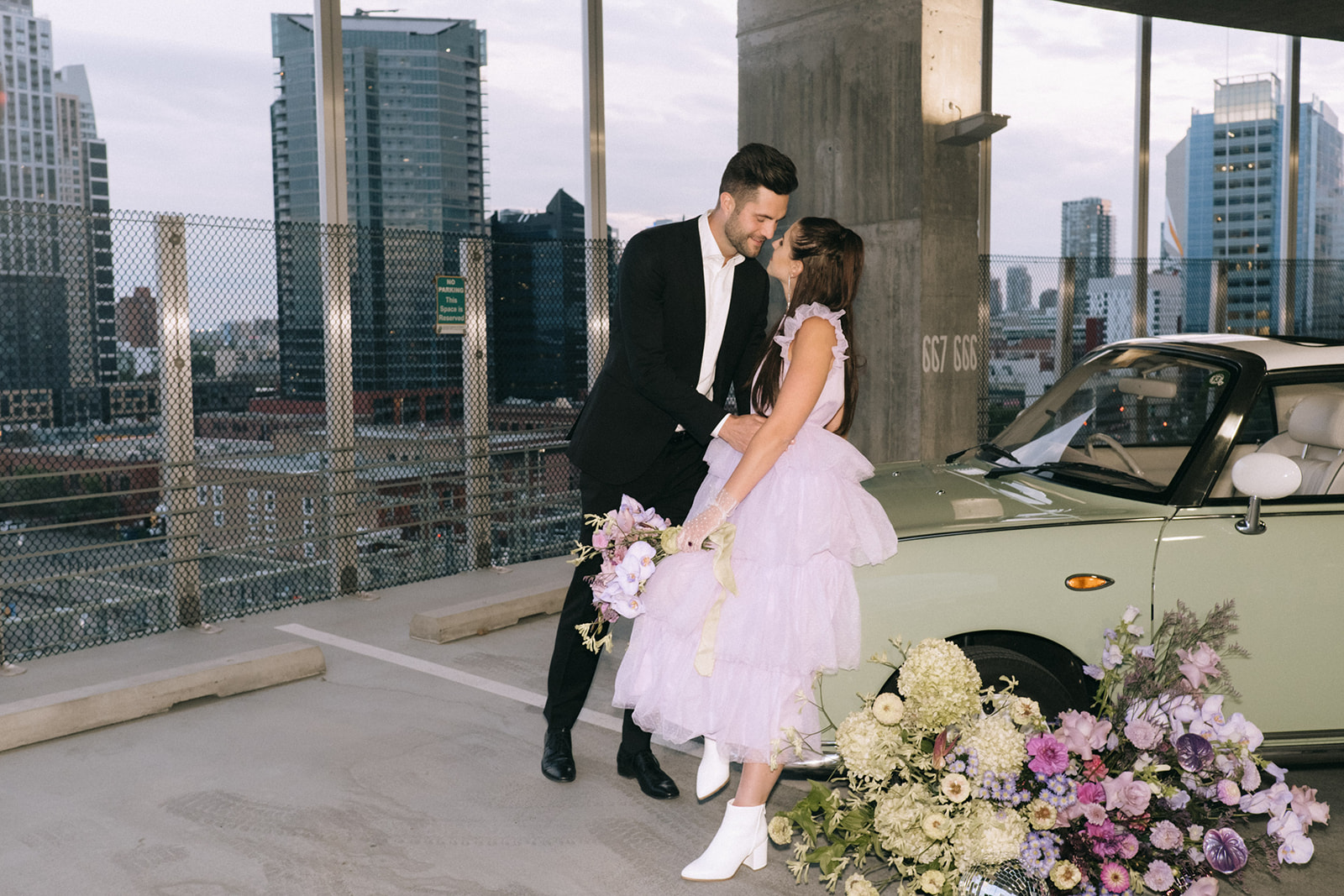 retro wedding with tulle lavender gown, parking lot elopement, downtown wedding, vintage car for wedding, wedding portraits, purple, green and white wedding florals