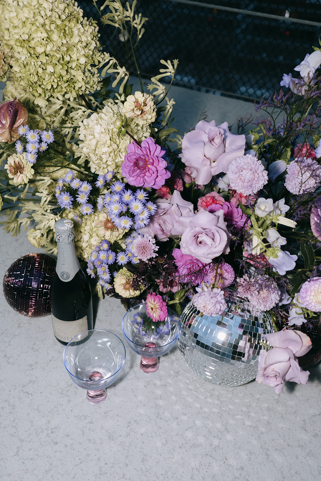 retro wedding with champagne and disco balls, bright purple, green and white floral inspiration 