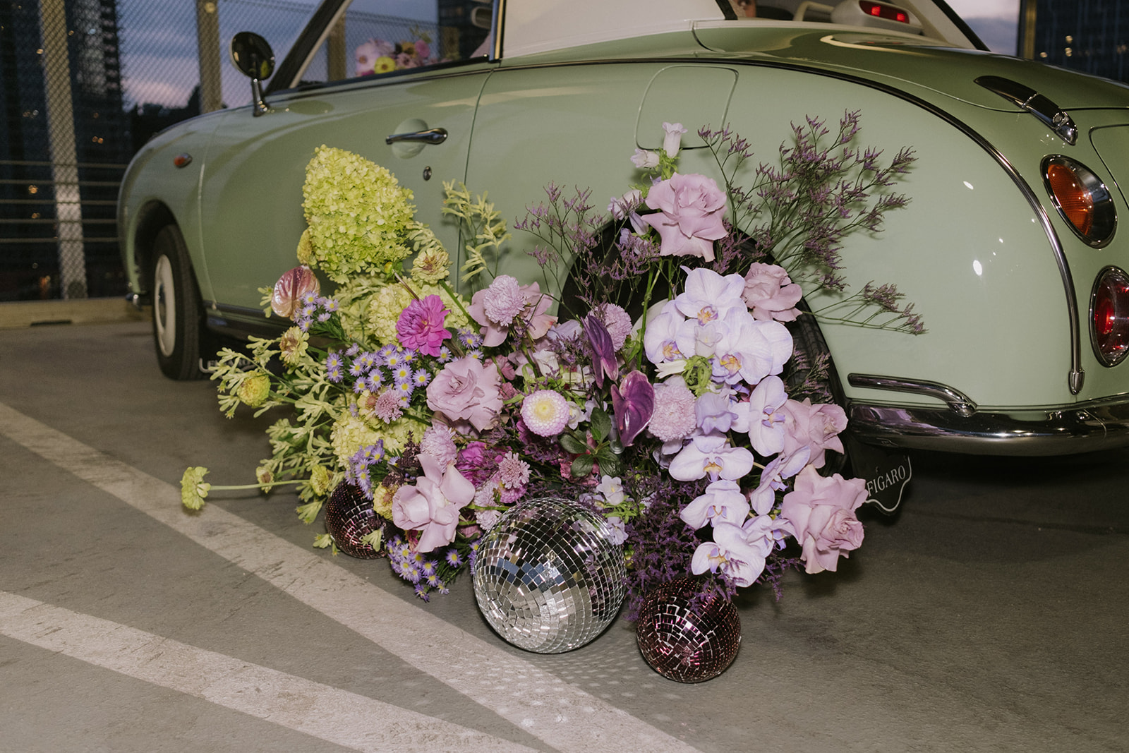 disco balls, vintage car, and purple flowers for retro elopement inspiration