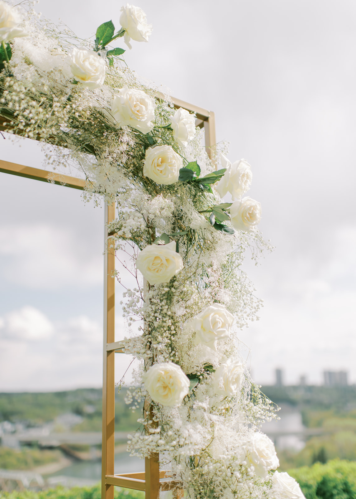 white and gold wedding arch, rose and baby's breath archway