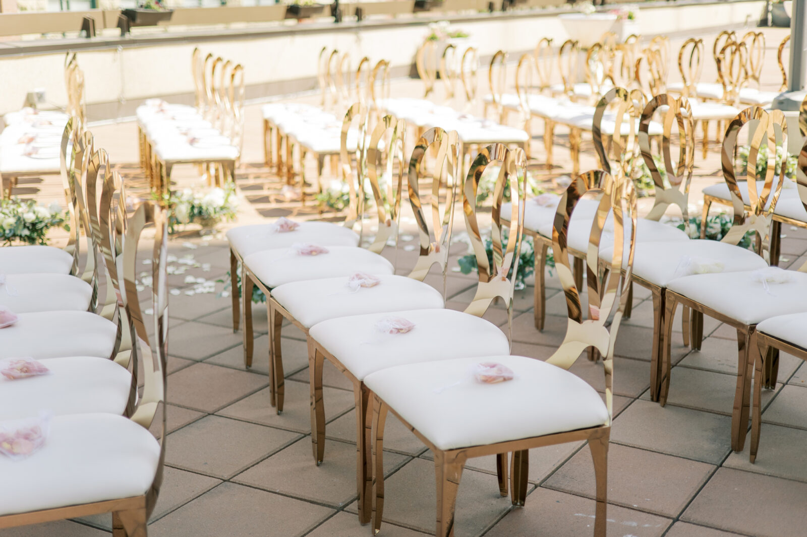 gold reception seating with floral pouches