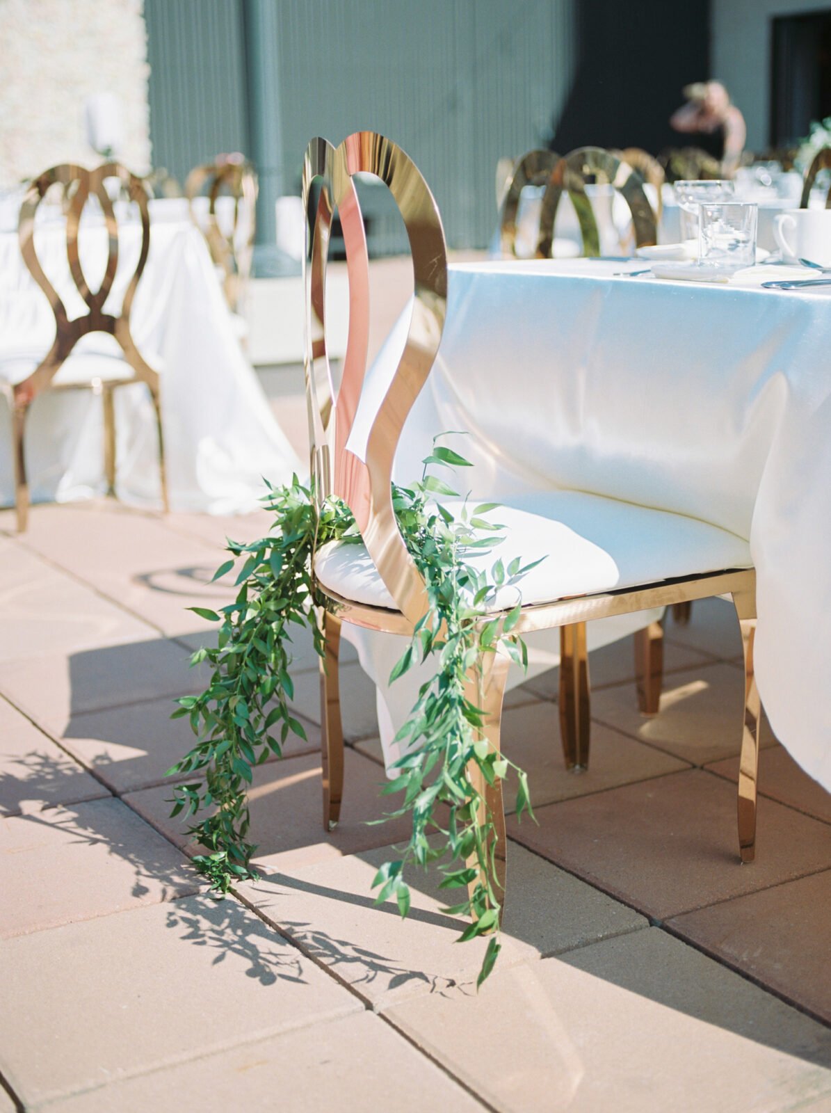 outdoor wedding reception with gold and greenery
