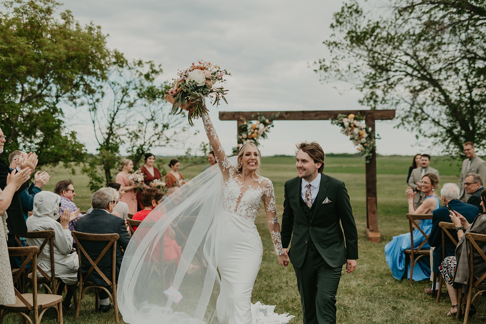 Bride and groom walk the aisle at backyard fall wedding, vintage wedding with bright florals