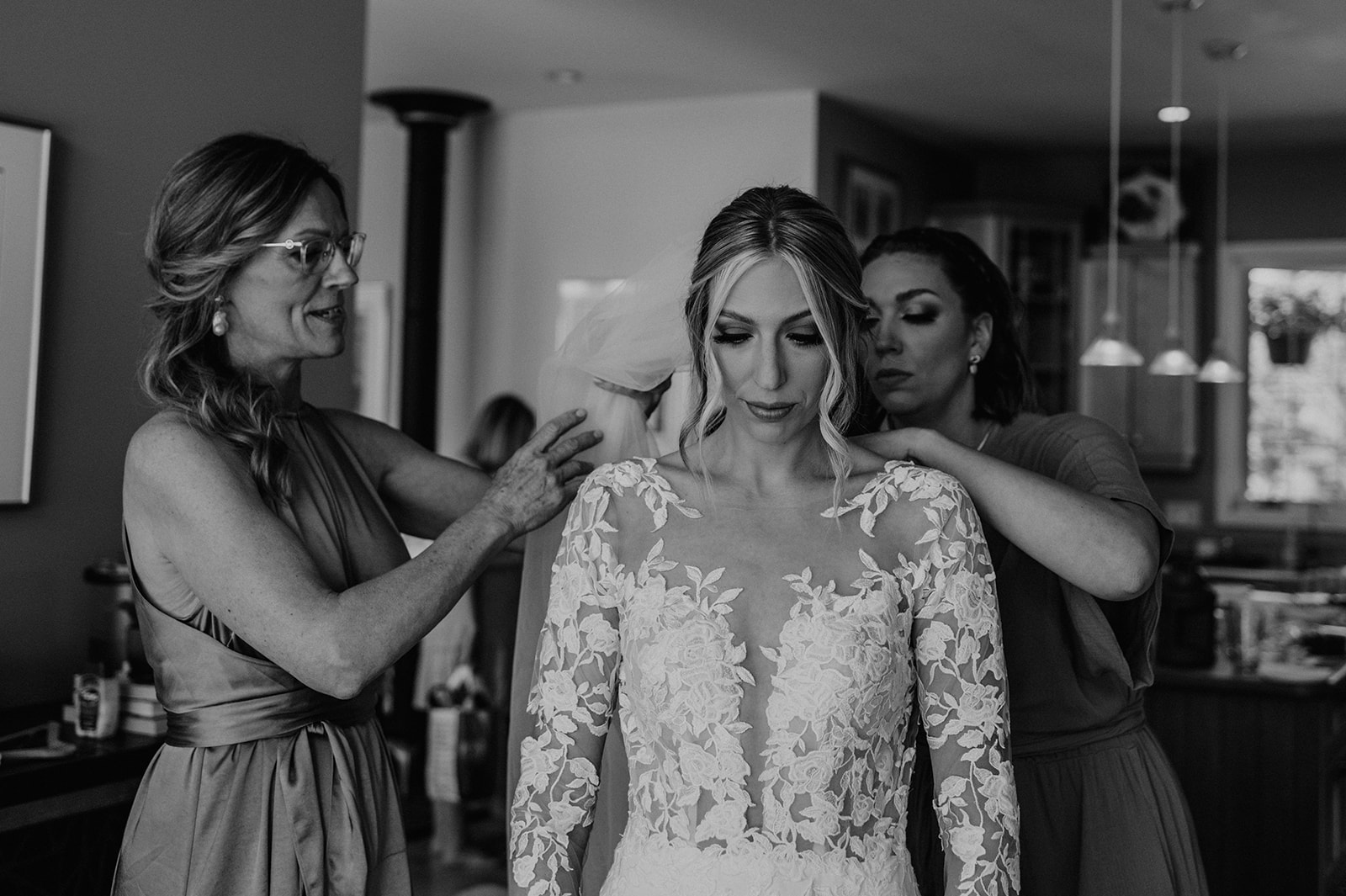 black and white wedding photography, bride putting on wedding gown