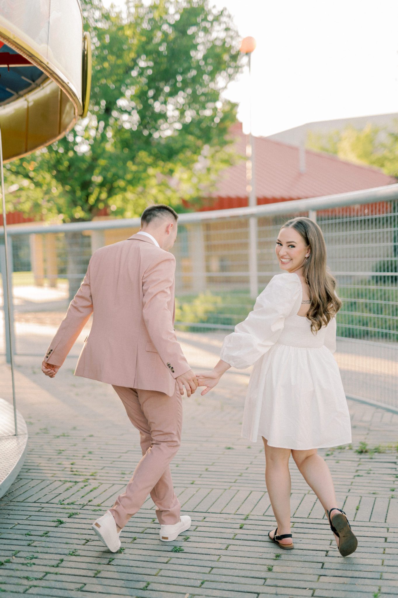 Unique engagement session location at outdoor carnival in summer