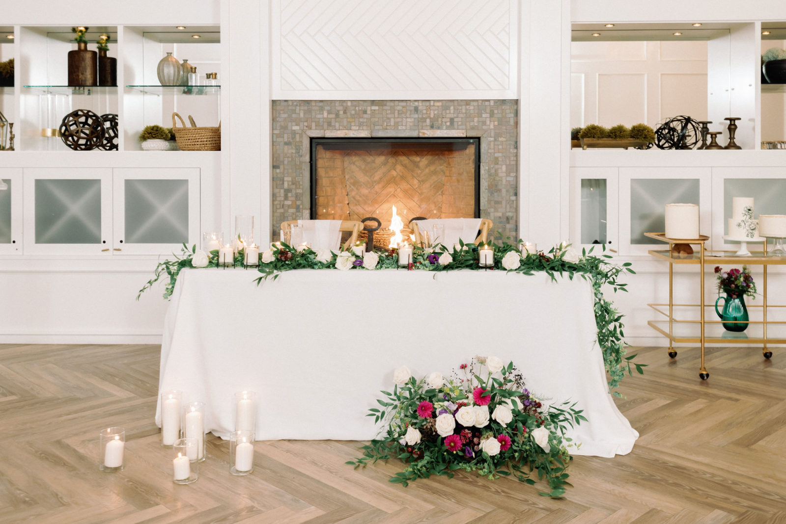 fireplace sweetheart table with candles and greenery, bright jewel toned wedding florals, Jewel toned Wedding Colour palette