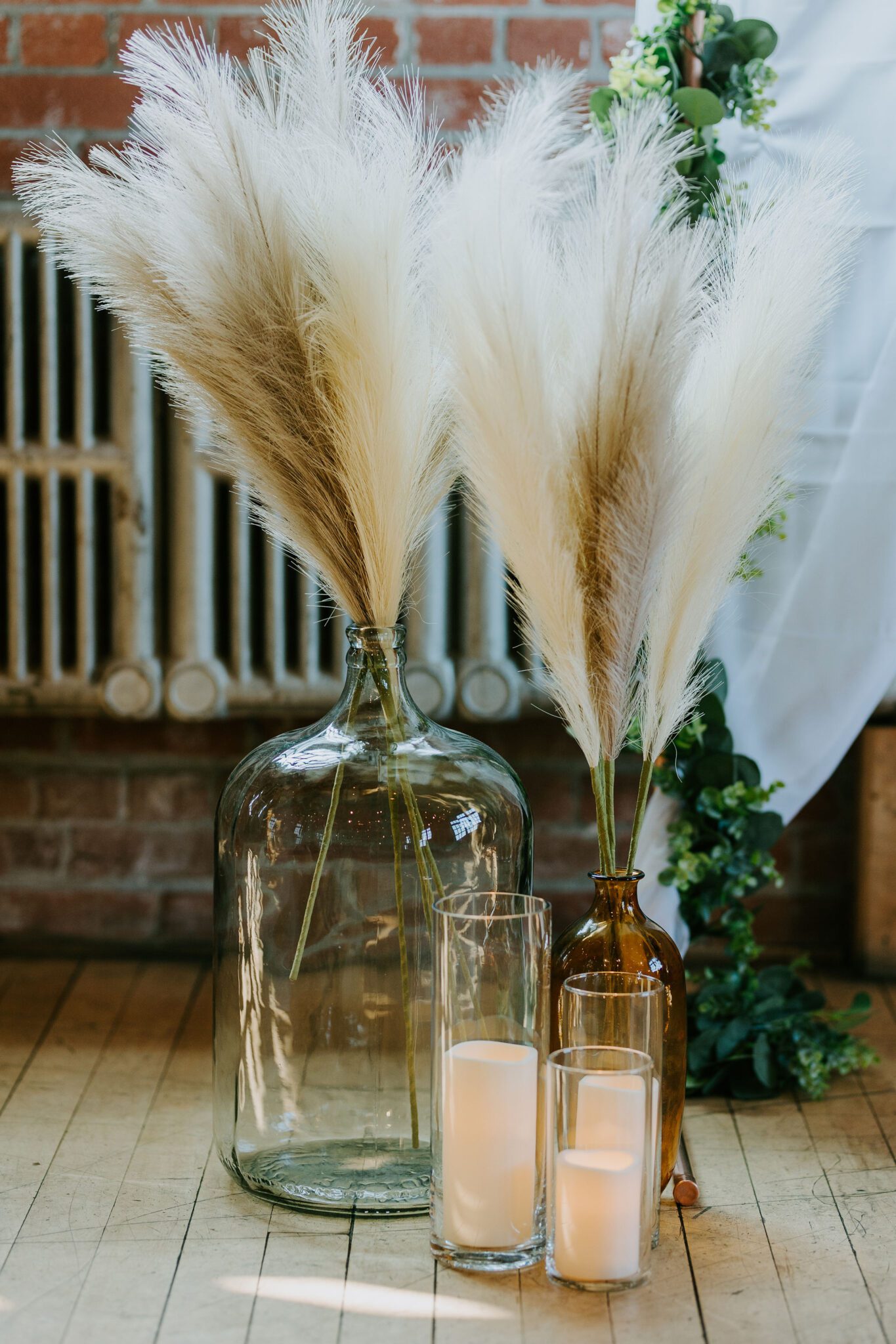 coloured vases and pampas grass with candles