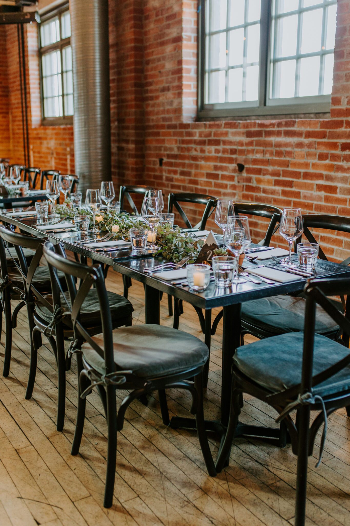 succulent wedding place cards, DIY wedding ideas, wedding reception; intimate and sentimental fall wedding reception at Char Bar restaurant in Calgary, black chairs and wooden tables in an industrial brick venue