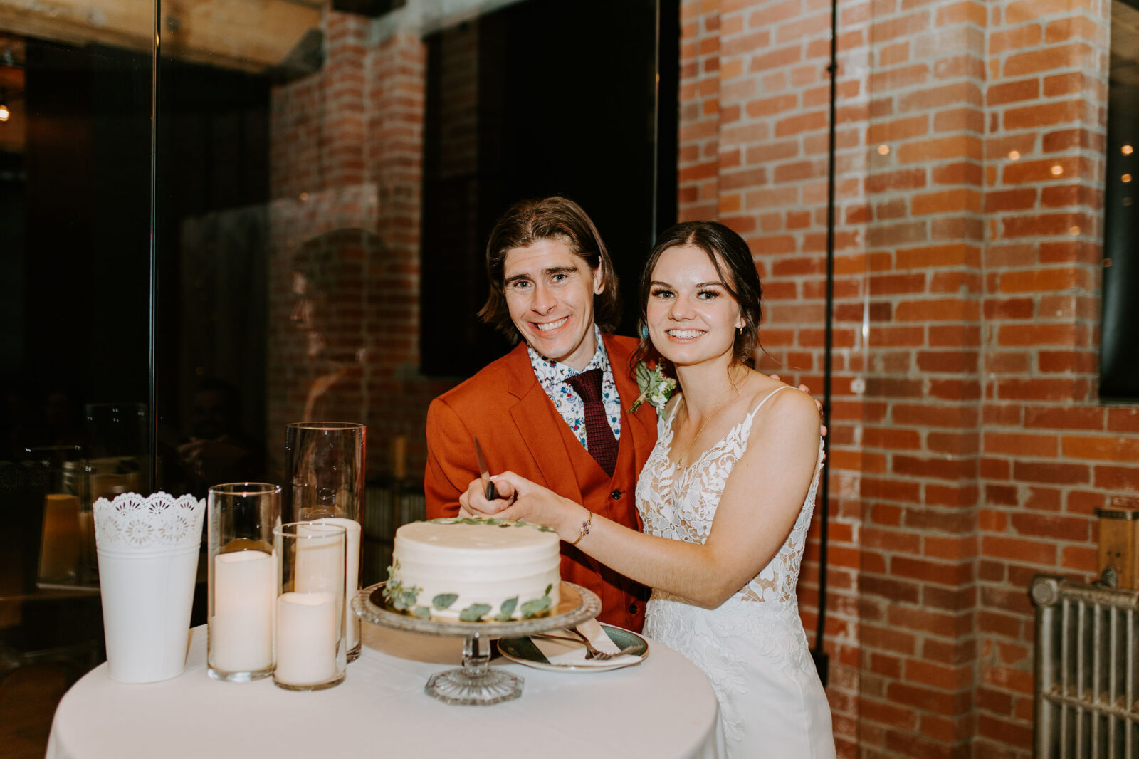 cake cutting, one-tier wedding cake with greenery; intimate and sentimental fall wedding reception at Char Bar restaurant in Calgary