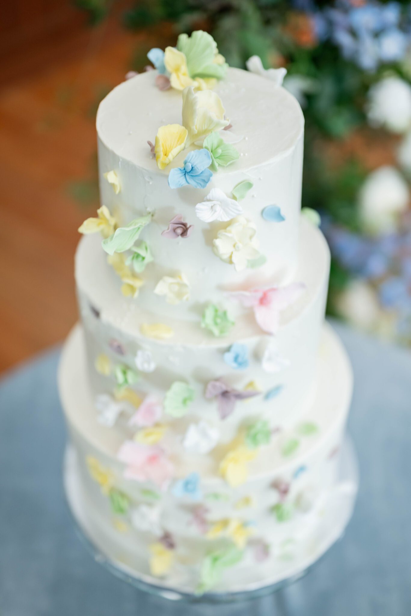 whimsical and romantic pastel wedding cake inspiration, sugar flower elements decorating a white tiered cake in soft hues and delicate tones, four-tiered wedding cake by Mish-T Cakes for spring wedding 