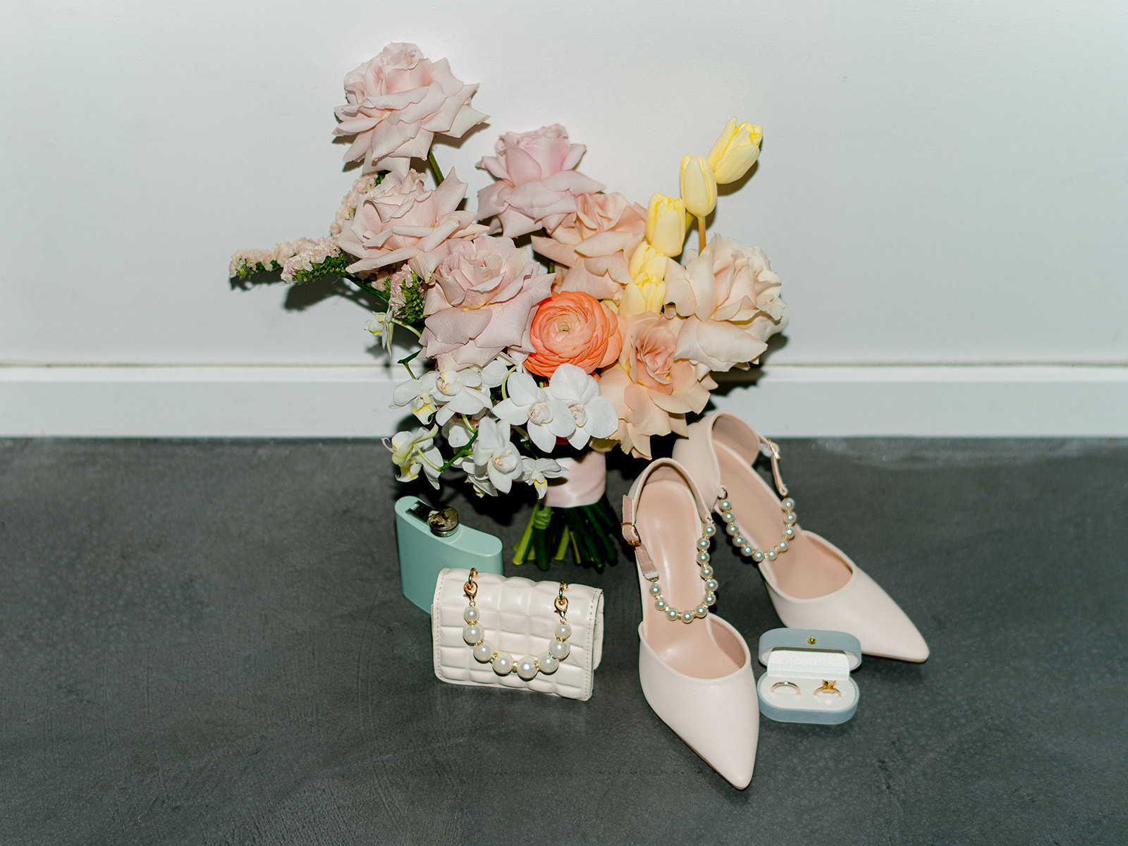 Colourful bridal bouquet captured in detailed photo alongside blue velvet ring box, tiffany blue flash and mini quilted bridal purse, studio wedding venue ideas, modern bridal accessories