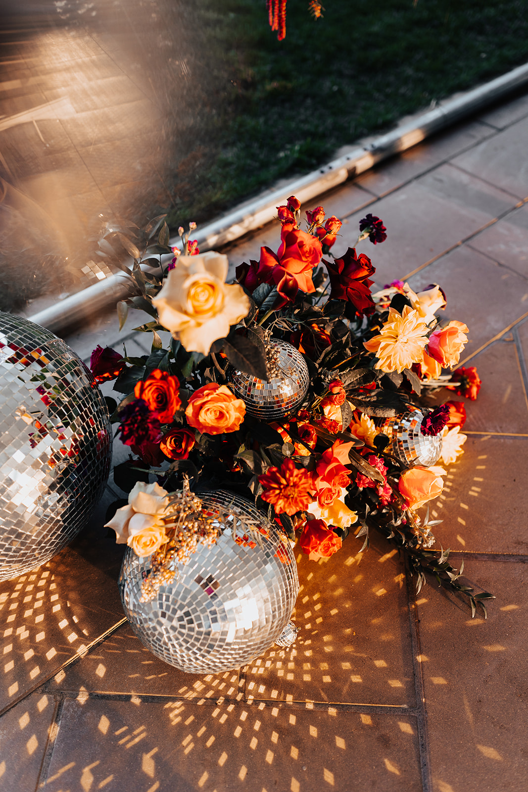 Retro wedding bouquet with disco balls, red and orange outdoor wedding 