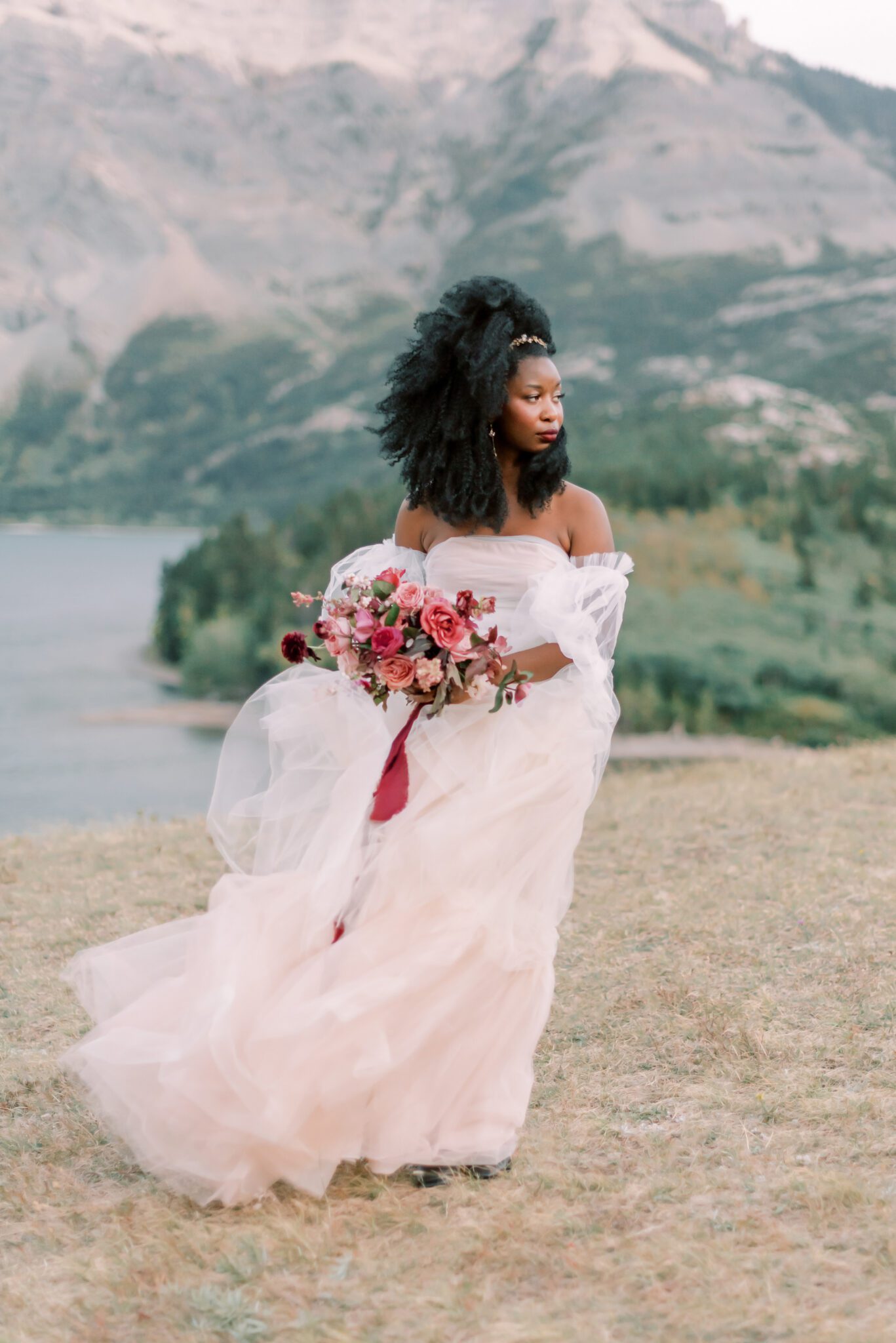 Bride wearing blush tulle wedding dress by Alexandra Victoria Rose, Waterton, Alberta outdoor bridal portrait