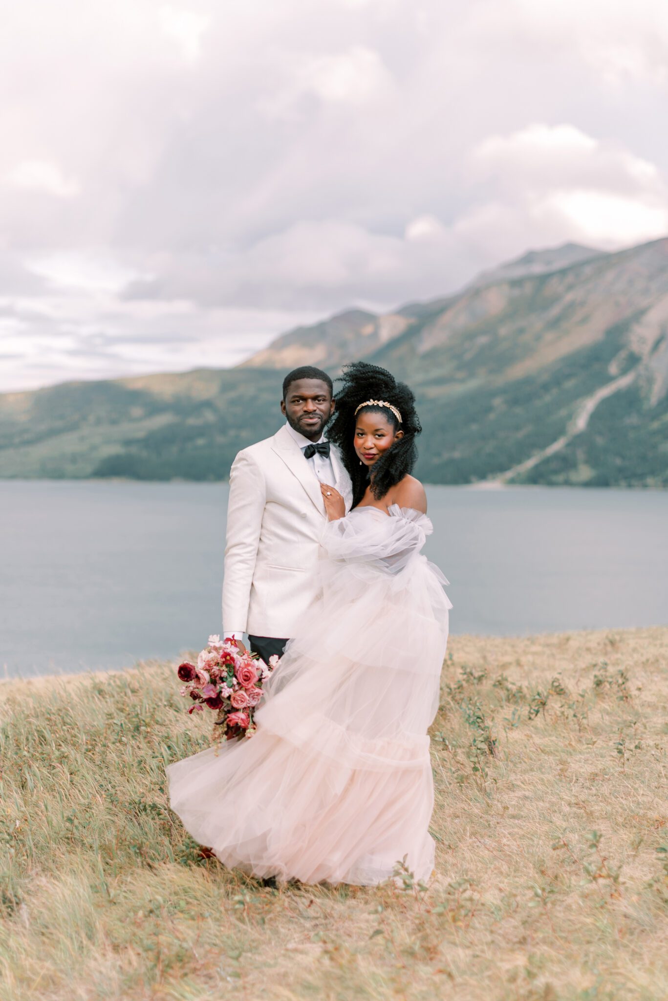 couple portraits in mountain landscape in Waterton, Alberta, bridal bouquet by Alexandra Victoria Rose, fall elopement portraits