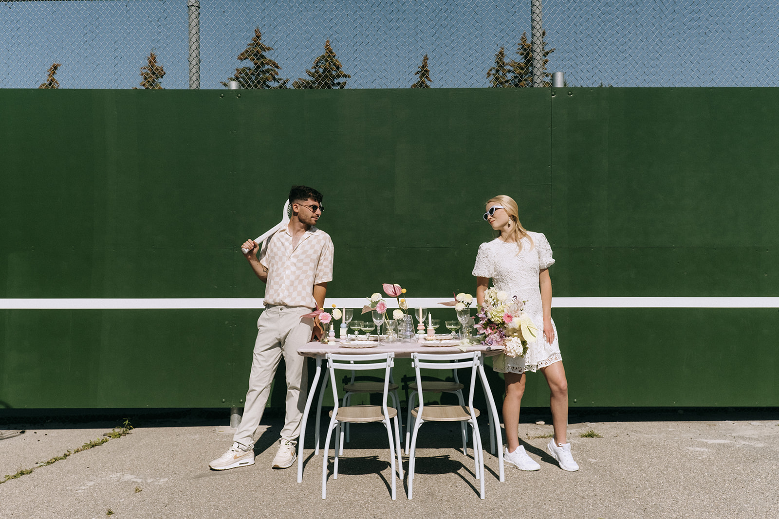 unique and sporty elopement inspiration, bride wearing short lace wedding dress and white sneakers for a casual vibe, intimate and modern sweetheart table